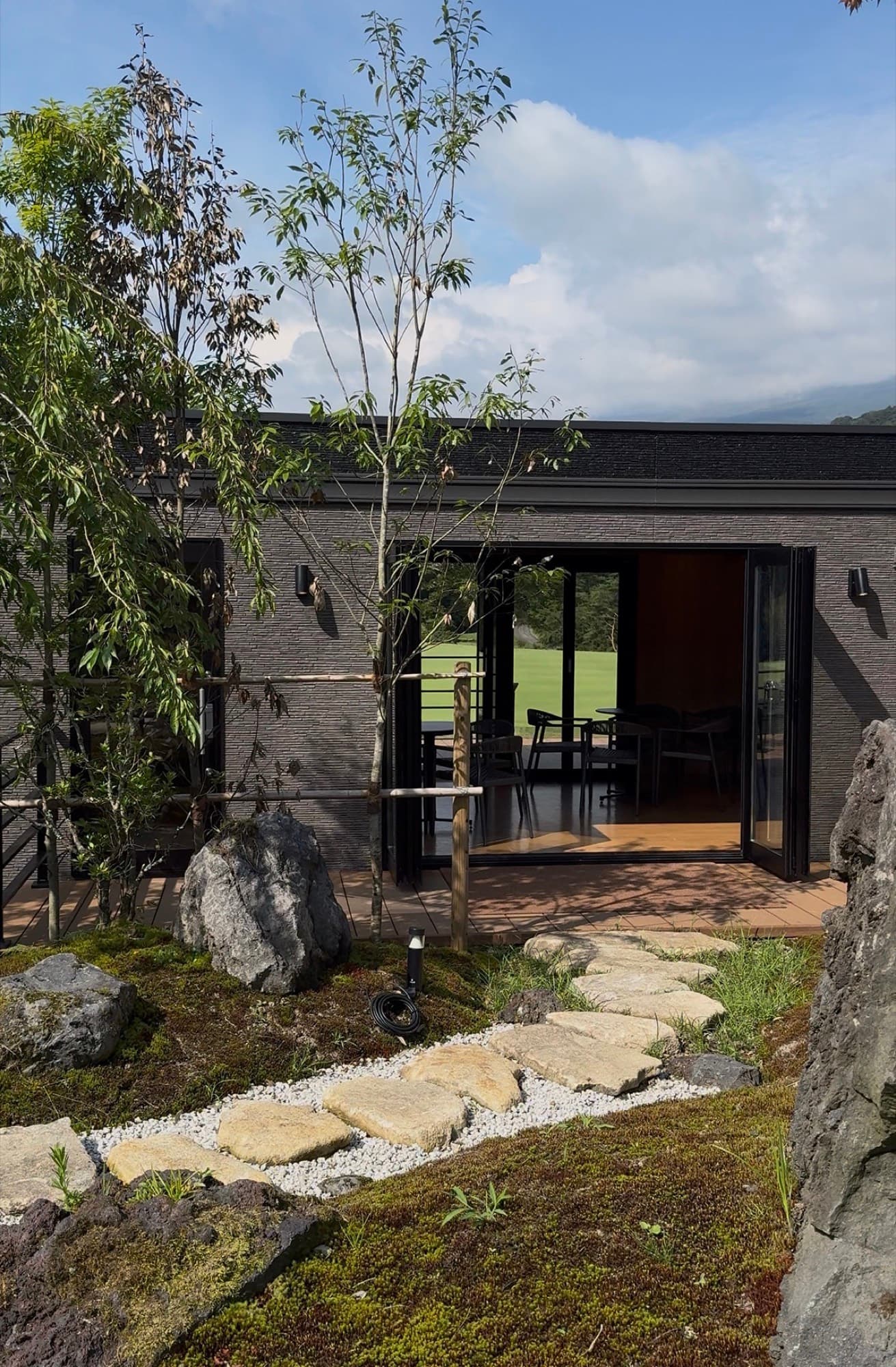 THE CAFE, a glass pavilion set in a moss-and-stone garden