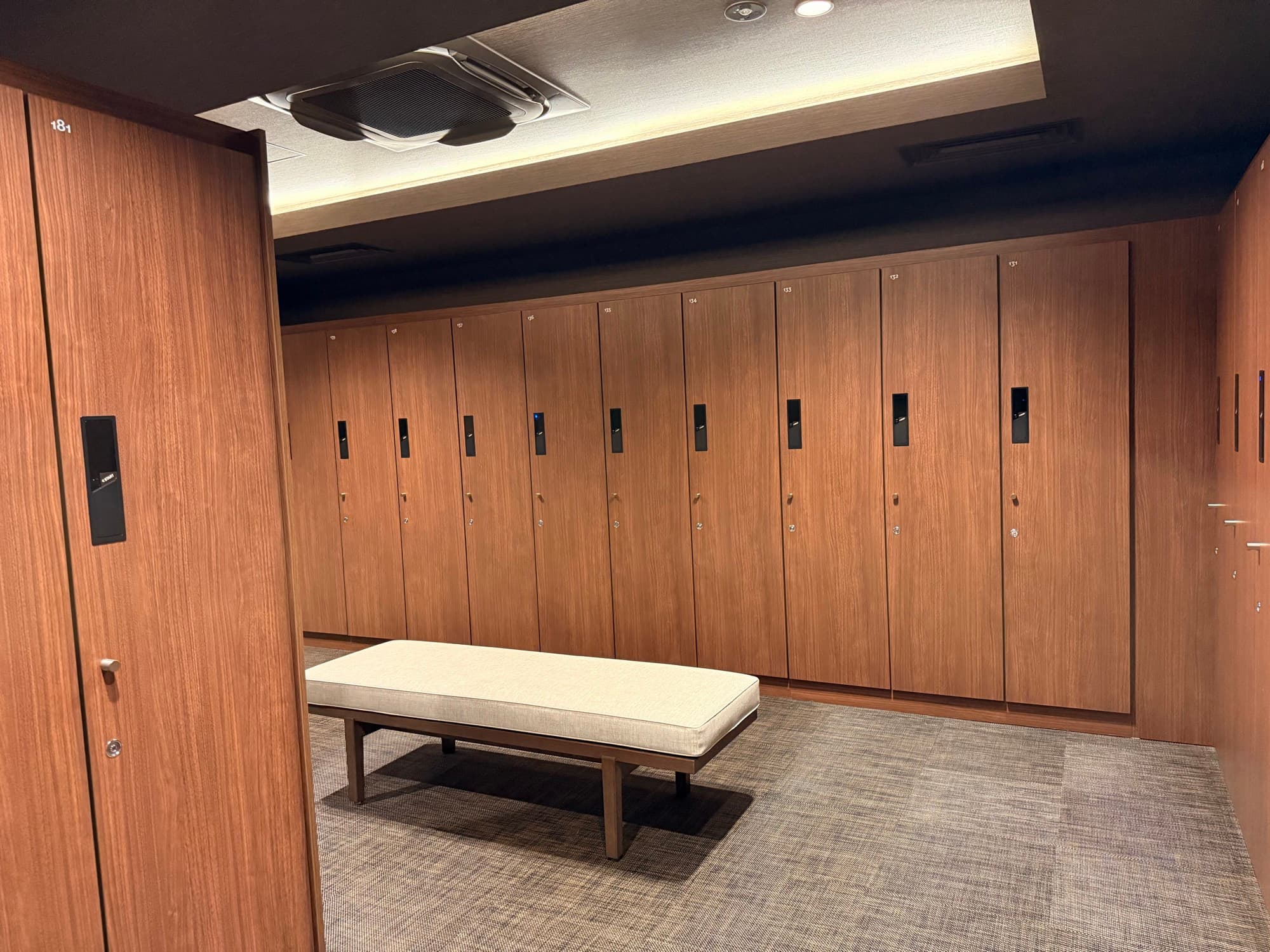 The locker room, panelled in warm wood
