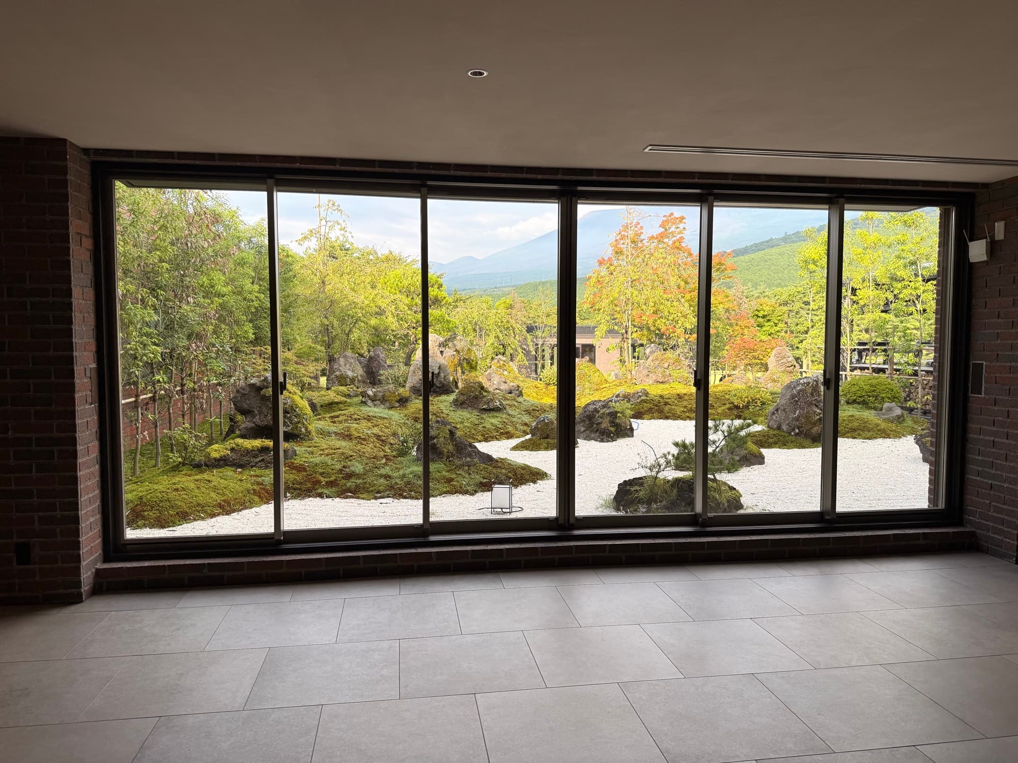 The clubhouse lounge at Gora Kadan Fuji Golf, a wall of glass onto a dry stone garden