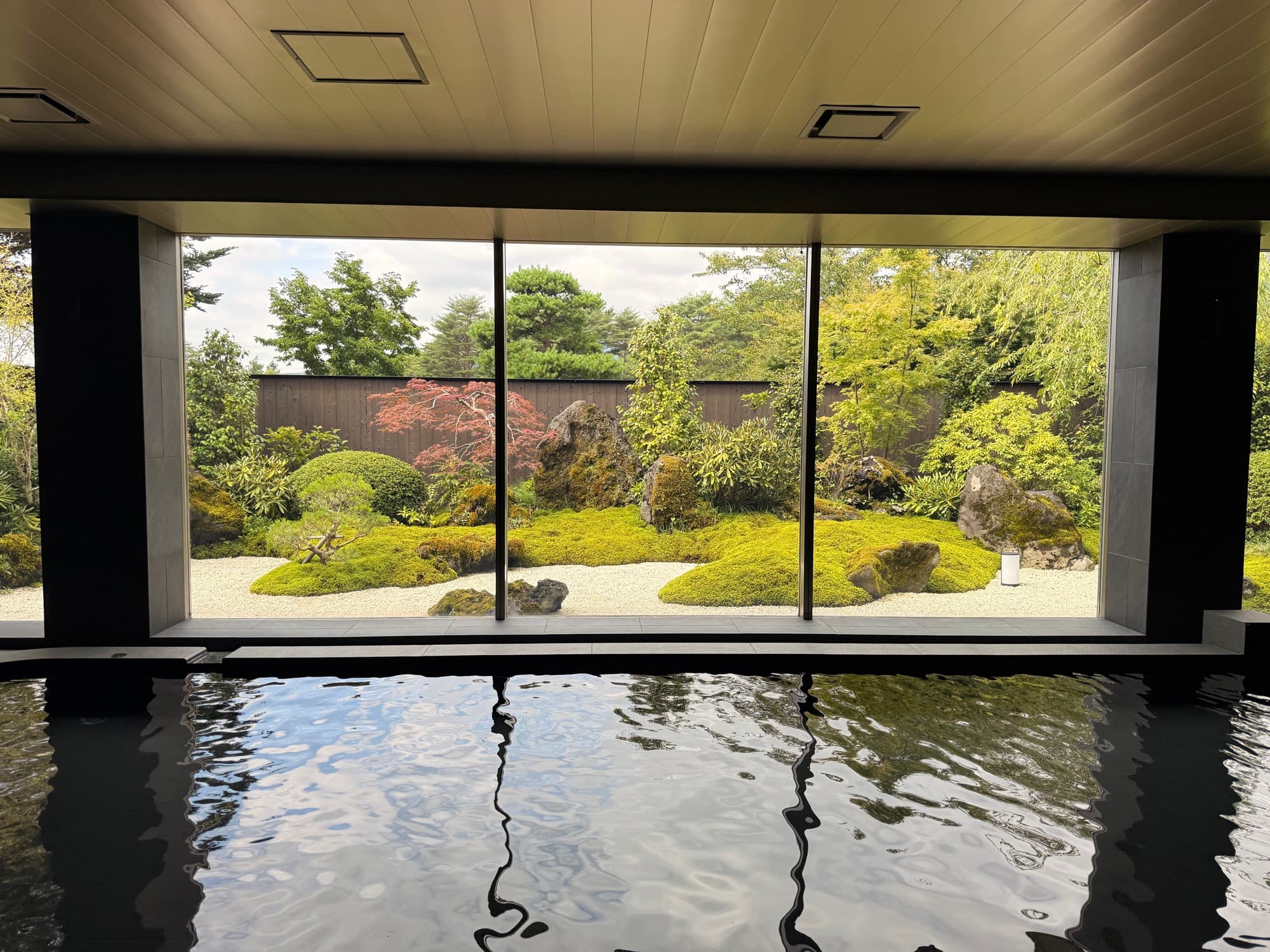 The onsen looking out over still water and a stone garden