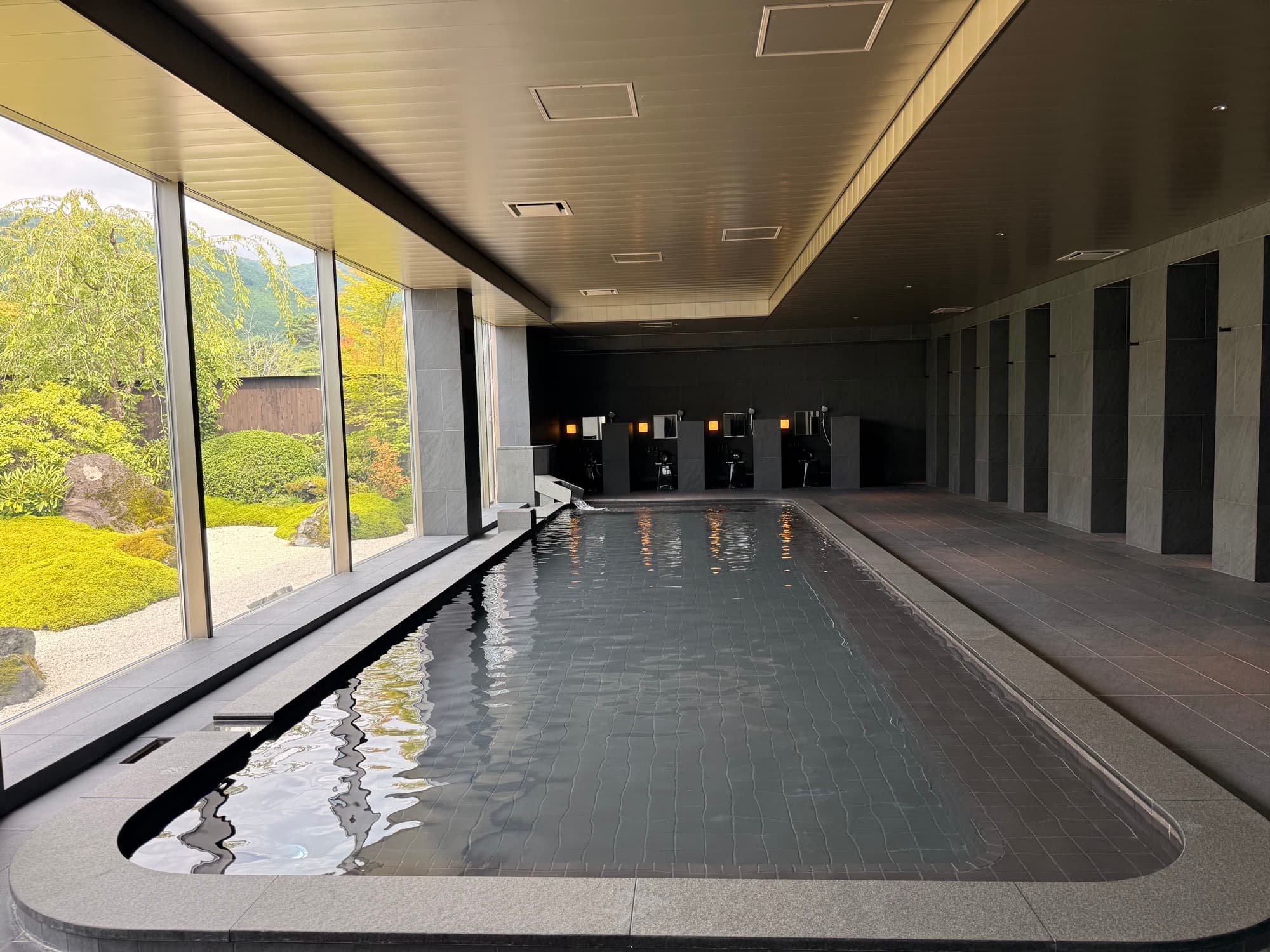 The bath beneath a long run of windows onto the garden