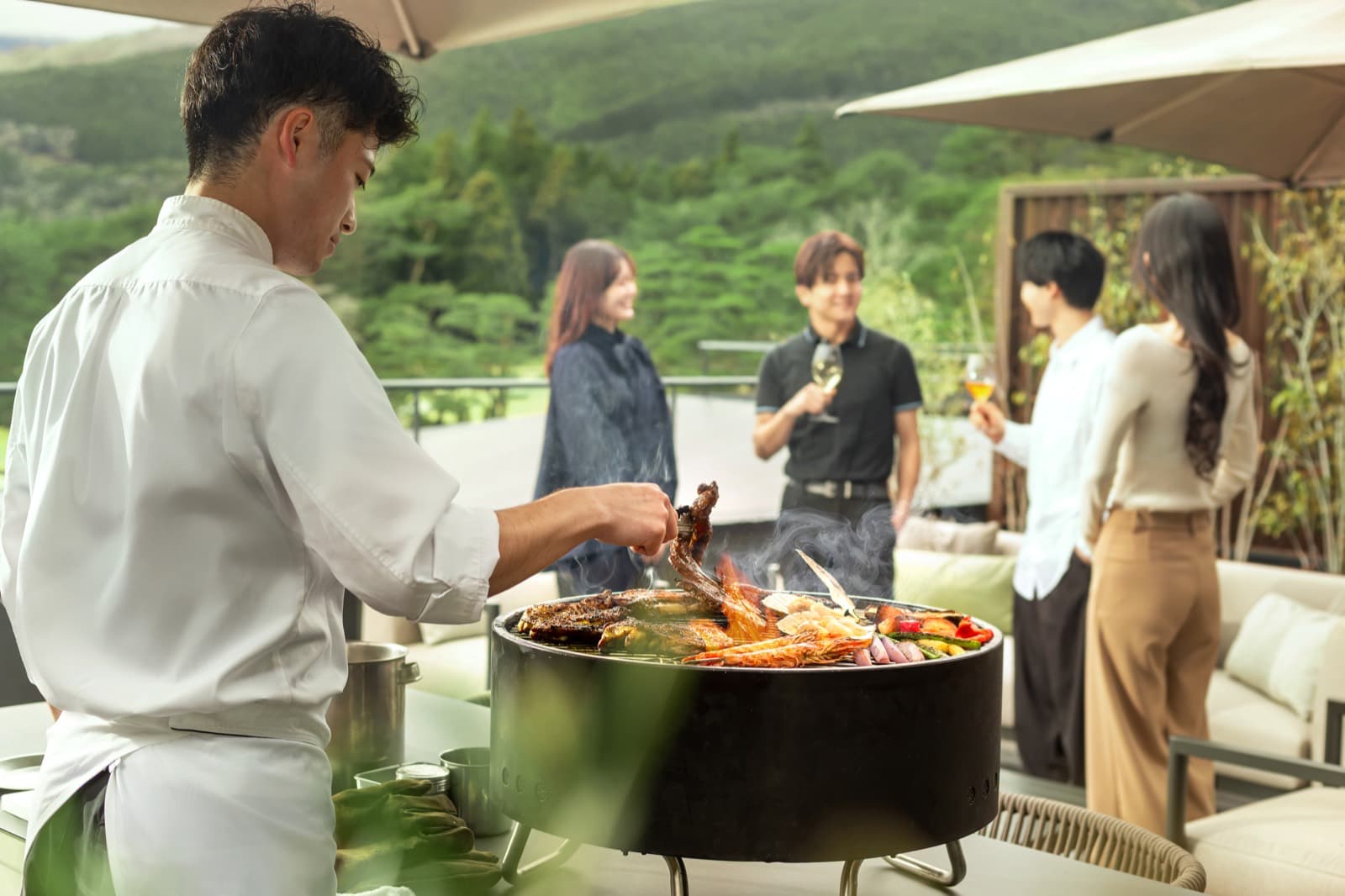 Dedicated chef grilling BBQ on the suite terrace