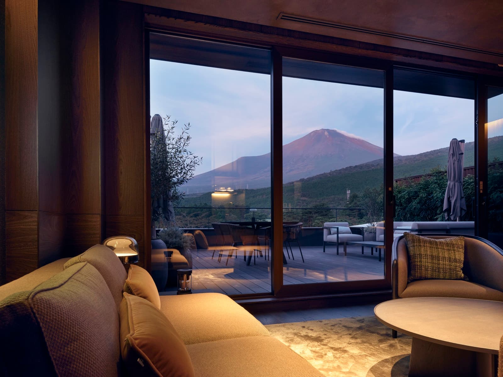 Suite room lounge with Mt. Fuji framed in the window at dusk