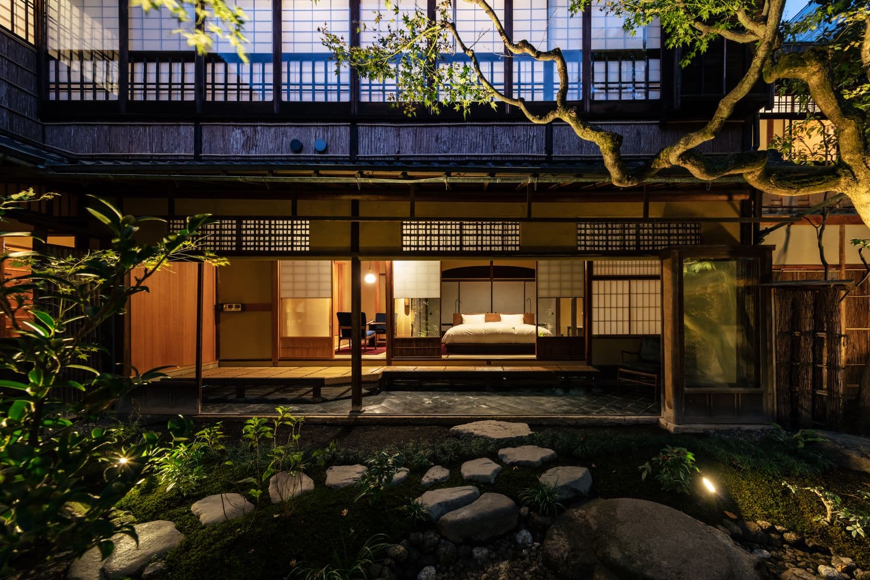 The restored SOWAKA machiya facade in Gion, Kyoto, lit at dusk